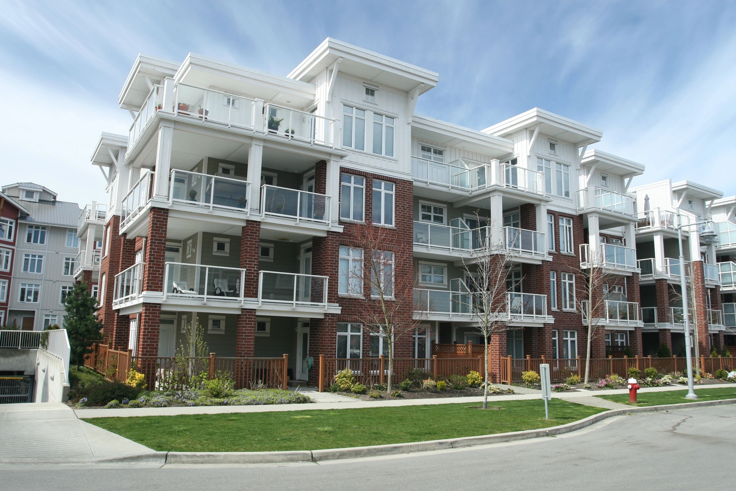 Newly constructed condominium building in suburban setting.